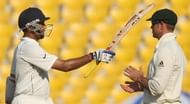 Indian cricketer VVS Laxman (L) raises h
